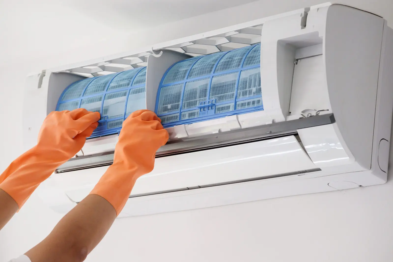 Technician cleaning an air-conditioning filter