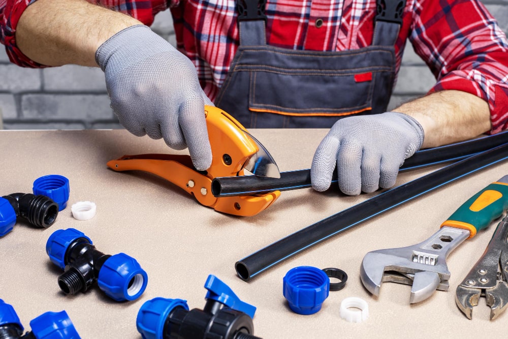 Engineer preparing plumbing tools and pipework for service work
