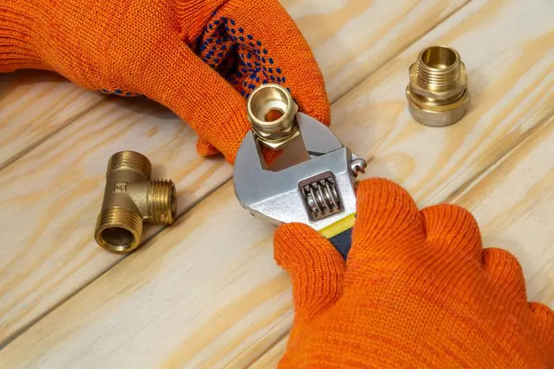 Plumbing tools and pipe fittings prepared for an urgent repair for emergency plumbing in Burpham