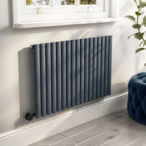 Modern radiator installed beneath a window in a living room