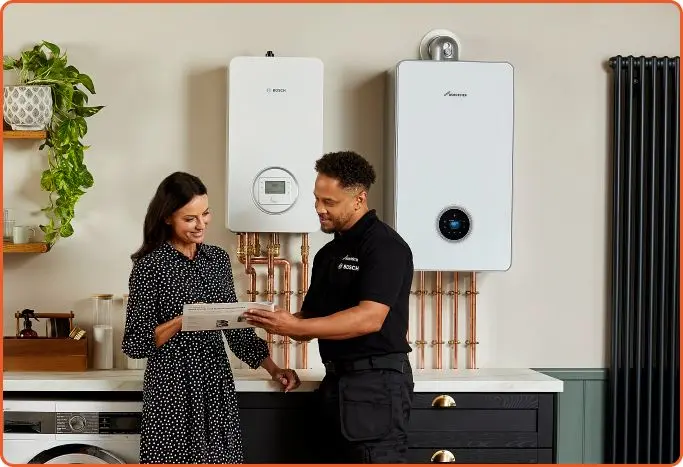Homeowner discussing two wall-mounted boiler options with an installer