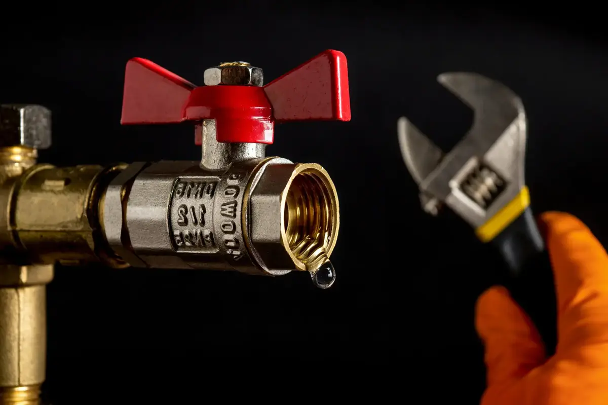 Engineer working beside a water isolation valve and hand tools